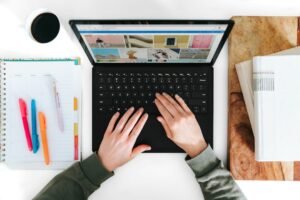 Laptop and study materials for planning an online learning platform